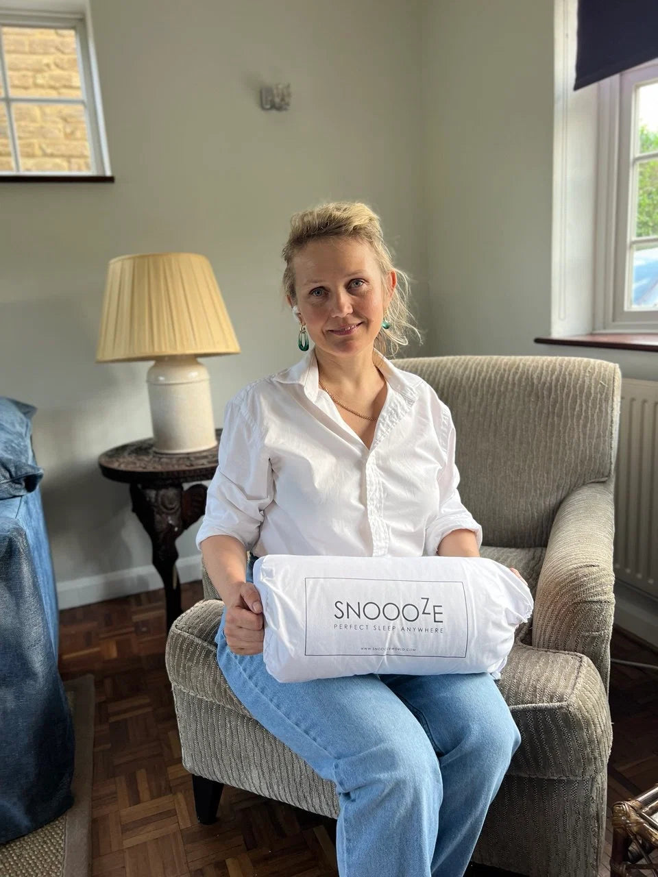LilPillo owner holding a current pillow with visible Snoooze branding